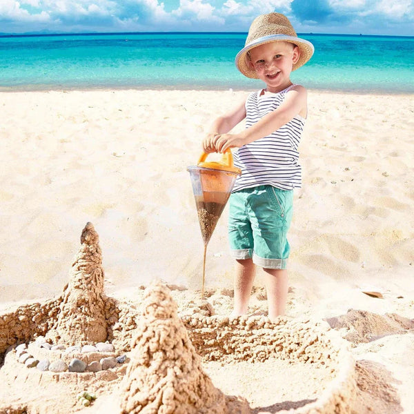 Beach toys overflowing sand from funnel